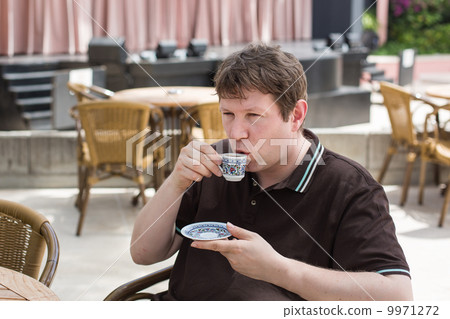 Young man drinking traditional turkish mocca coffee 9971272