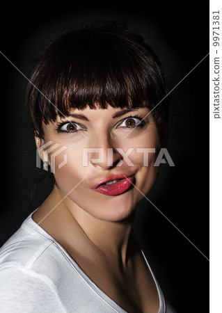 Playful caucasian woman making a funny face Playful caucasian woman making a funny face 9971381