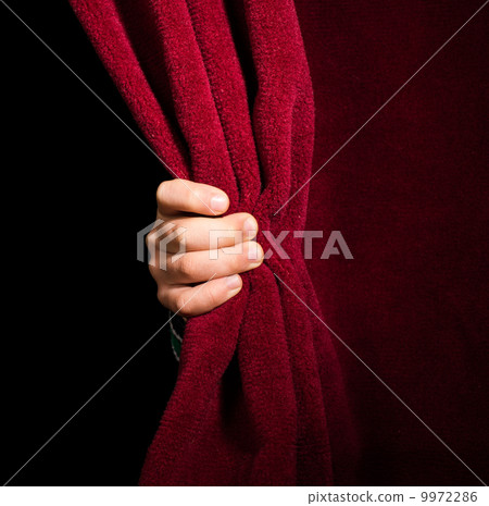 Hand appearing beneath the curtain. Hand appearing beneath the curtain. 9972286