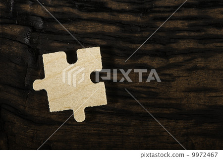 Wooden puzzle on dark background. Wooden puzzle on dark background. 9972467