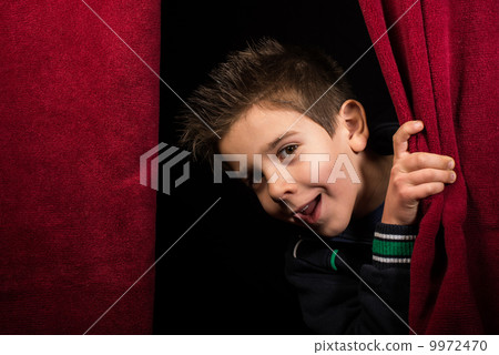 Child appearing beneath the curtain Child appearing beneath the curtain 9972470