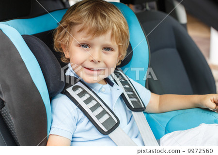 Stock Photo: Little boy sitting in safety car sea