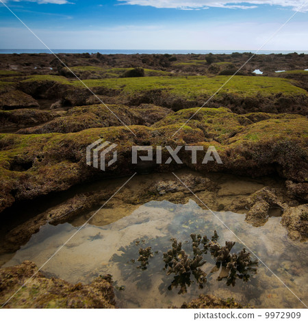 Sunset at tropical beach with rocks and stones Sunset at tropical beach with rocks and stones 9972909