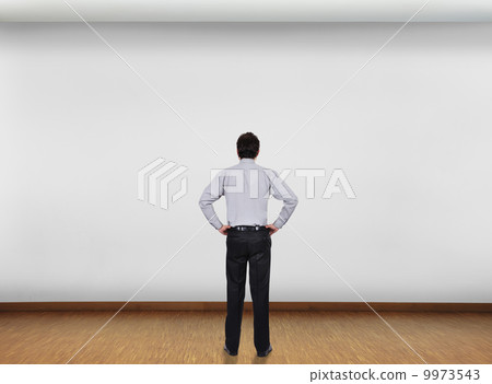 businessman looking at wall 9973543