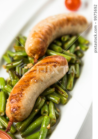 roast sausages on garnish from green haricot roast sausages on garnish from green haricot 9975692
