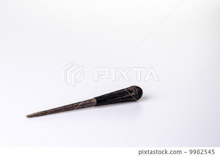 Old black screwdriver on white background 9982545
