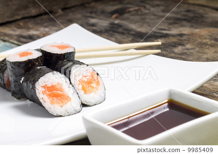 Makisushi on white plate. Seafood traditional maki sushi rolls with chopsticks 9985409