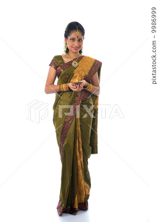 indian female in traditional clothes with lamp full body indian female in traditional clothes with lamp full body 9986999