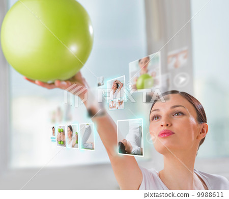Sporty woman working out using modern virtual interface 9988611