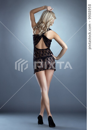 Rear view of cute woman posing in lacy negligee 9988958