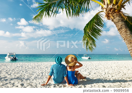 Couple in blue clothes on a beach at Maldives Couple in blue clothes on a beach at Maldives 9989956