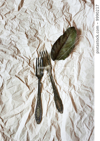Vintage cutlery on a paper background Vintage cutlery on a paper background 9990217