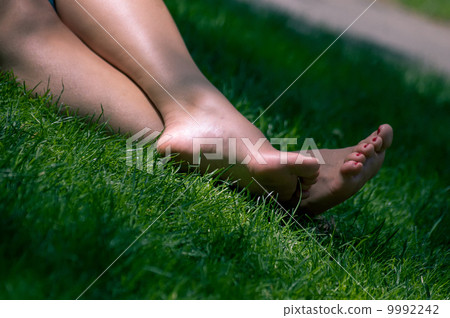 Womens legs on grass  9992242