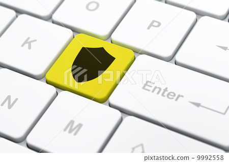 Privacy concept: Shield on computer keyboard background 9992558