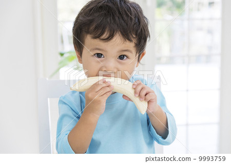 A boy who eats a banana 9993759