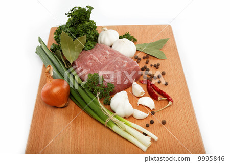 raw meat, vegetables and spices isolated on a wooden table. 9995846