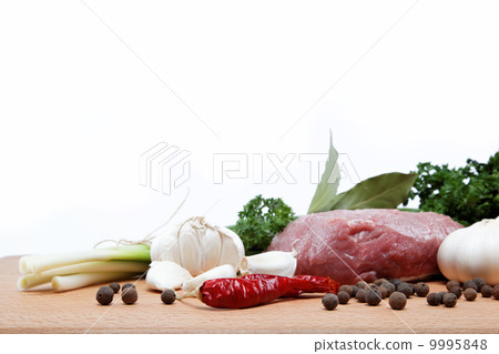 raw meat, vegetables and spices isolated on a wooden table. 9995848
