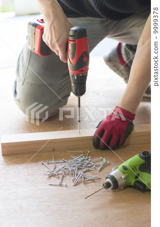 DIY image Male hand driving a screw DIY image Male hand driving a screw 9999378