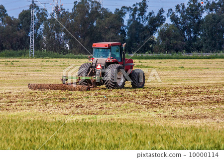 Tractor on agricultural field. Tractor on agricultural field. 10000114