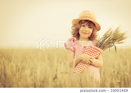 Happy child holding wheat Happy child holding wheat 10001489