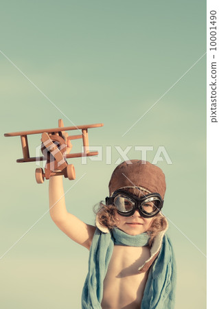Happy kid playing with toy airplane Happy kid playing with toy airplane 10001490