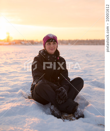 girl sitting on the snow and smiling girl sitting on the snow and smiling 10001612