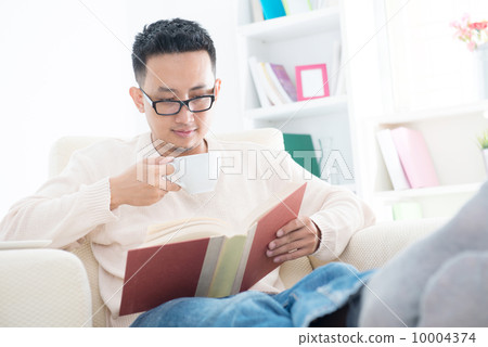 Southeast Asian male reading a book Southeast Asian male reading a book 10004374