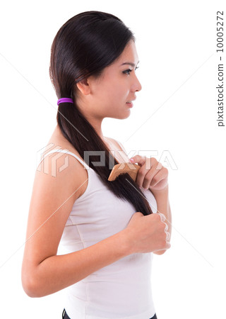 Side view Asian girl combing hair 10005272