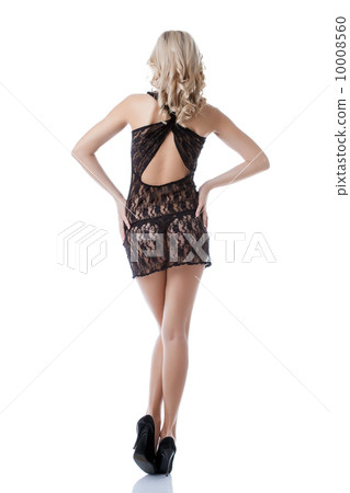Rear view of sexy blonde posing in erotic negligee 10008560