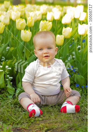 young adorable cheerful baby sit in park on green grass and play young adorable cheerful baby sit in park on green grass and play 10008717