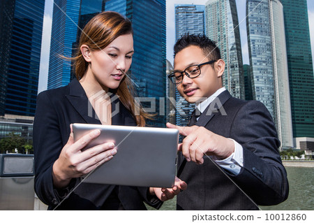 Young business executives discussion with a tablet pc Young business executives discussion with a tablet pc 10012860