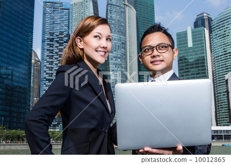 Young business executives having a discussion using a laptop Young business executives having a discussion using a laptop 10012865