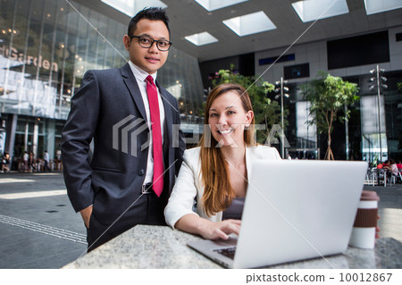 Young business executives discussing Young business executives discussing 10012867