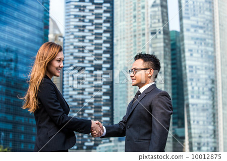 Young business executives shaking hands Young business executives shaking hands 10012875