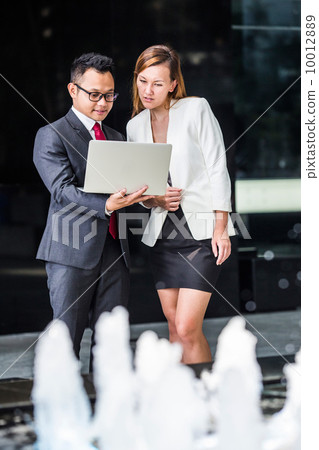 Young business executives having a discussion Young business executives having a discussion 10012889