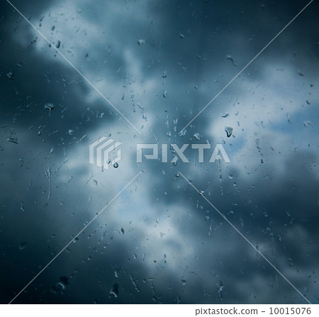 Rain drops on window across clouds Rain drops on window across clouds 10015076