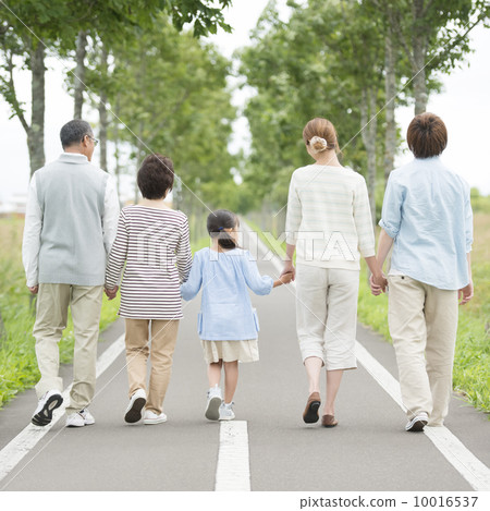 The back of the 3 generations family holding hands in one road 10016537