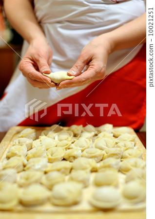 Woman making russian dumplings (pelmeni) Woman making russian dumplings (pelmeni) 10021251