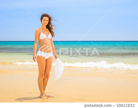 Young woman on ocean beach Young woman on ocean beach 10021832
