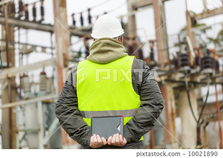 Electrician with tablet PC in electrical substation 10021890