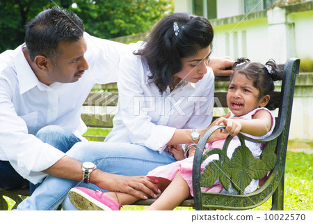 Parents is comforting their crying daughter. 10022570