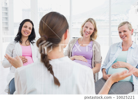 Pregnant women listening to doctor at antenatal class 10025221