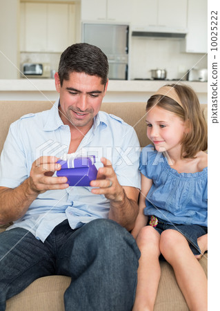 Father opening gift given by daughter 10025222