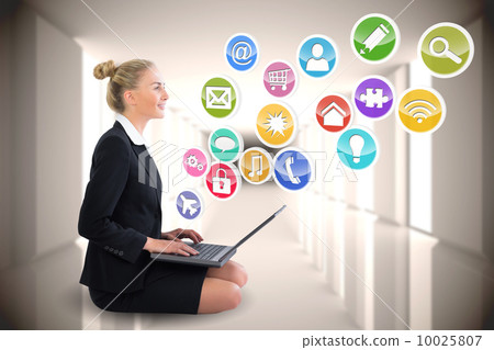 Blonde businesswoman sitting using laptop with app icons 10025807