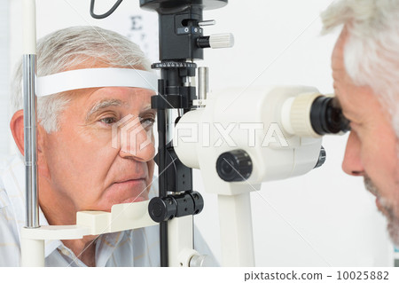Optometrist doing sight testing for senior patient Optometrist doing sight testing for senior patient 10025882