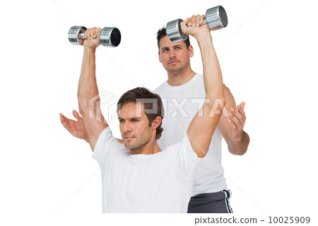 Male trainer assisting man with dumbbells Male trainer assisting man with dumbbells 10025909