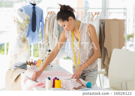 Female fashion designer working on fabrics 10026122