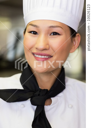 Closeup of a female cook in kitchen Closeup of a female cook in kitchen 10026123