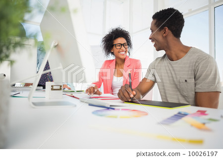 Happy casual photo editors using graphics tablet 10026197