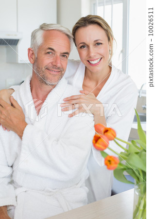 Happy couple smiling at camera in the morning